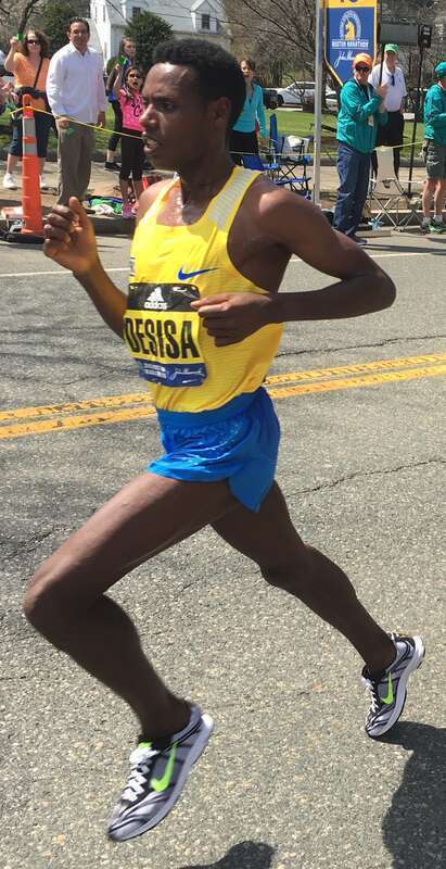 w:Lelisa Desisa leads w:Lemi Berhanu Hayle as they are the first men to pass mile 19 in Newton, Massachusetts during the w:2016 Boston Marathon. Hayle went on to win the elite men's division; Desisa came in second.