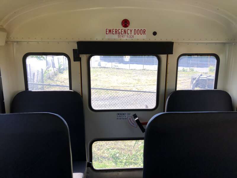 Rear-facing interior view from the rear of a First Student school bus at a bus depot in East Orange, Essex County, New Jersey