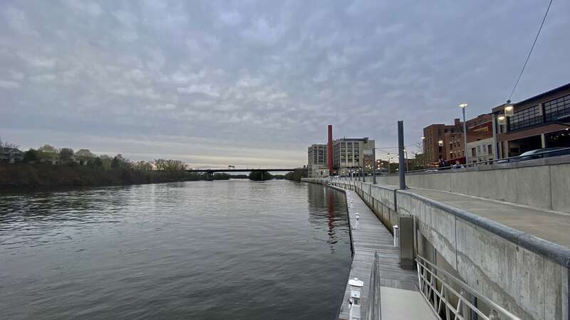 A view along the Hudson River shore in the northern part of downtown Troy, New York, as seen from the Downtown Marina on a May 2022 evening.