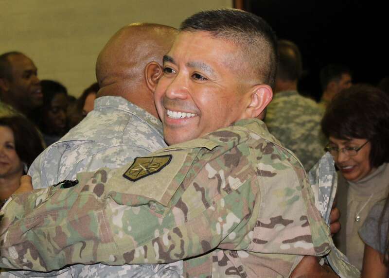 Augusta, Ga. Nov. 23, 2013 – Georgia Army National Guardsman Lt. Col. Ed Granados and 878th Engineer Battalion Commander hugs a fellow Soldier at the unit Armory Saturday night after nearly a year long deployment to Afghanistan with the 878th