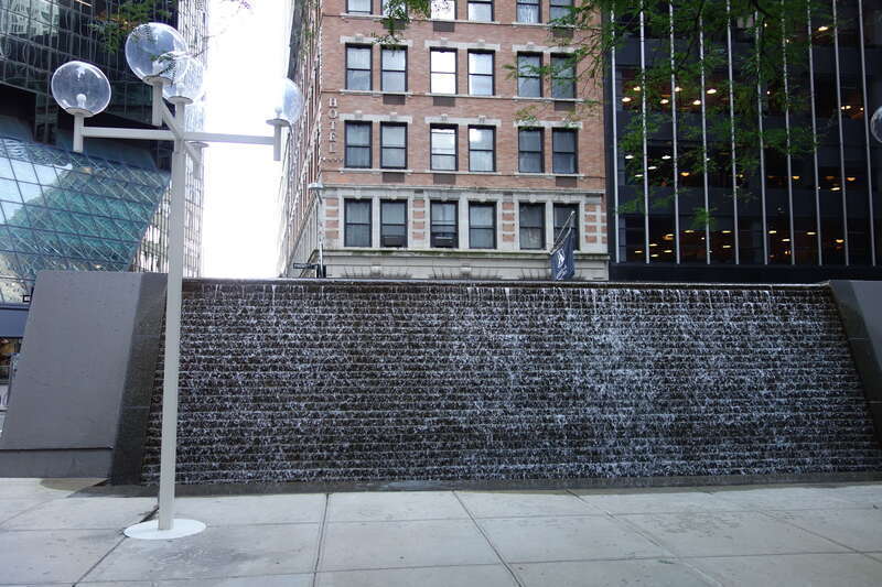 The water wall fountain at the south end 88 Pine Street Plaza, between Wall Street Plaza (88 Pine Street) and 100 Wall Street at Front Street and Pine Street in the Wall Street area of the Financial District, Manhattan.