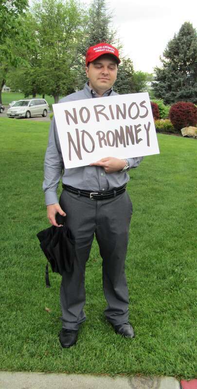 Protester at a Mitt Romney senate campaign rally with the sign "No RINOS No Romney".