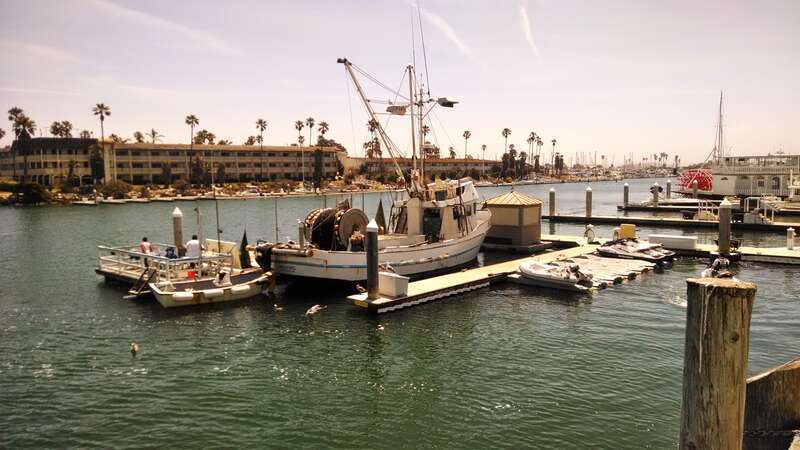 Fishing boat taken from commercial fishing boat unloading pier facing southeast with hotel in background