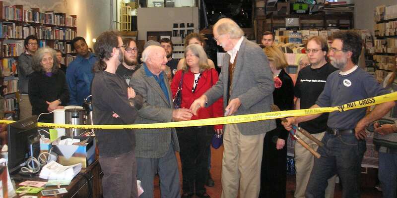 The Civic Media Center's new location is dedicated by Stetson Kennedy (left of center, in a gray jacket and blue shirt), who chose the CMC as the recipient of his extensive personal library, which contains about 2,000 books and publications he has