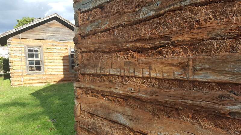 Closeup of mud and squared log construction.  The cabins of squared logs and hand-hewn limestone were built in the early 1850s near the village of Gabriel Mills, Texas.  They stood on property owned in 1850-53 by Samuel Mather (1812-78), miller and