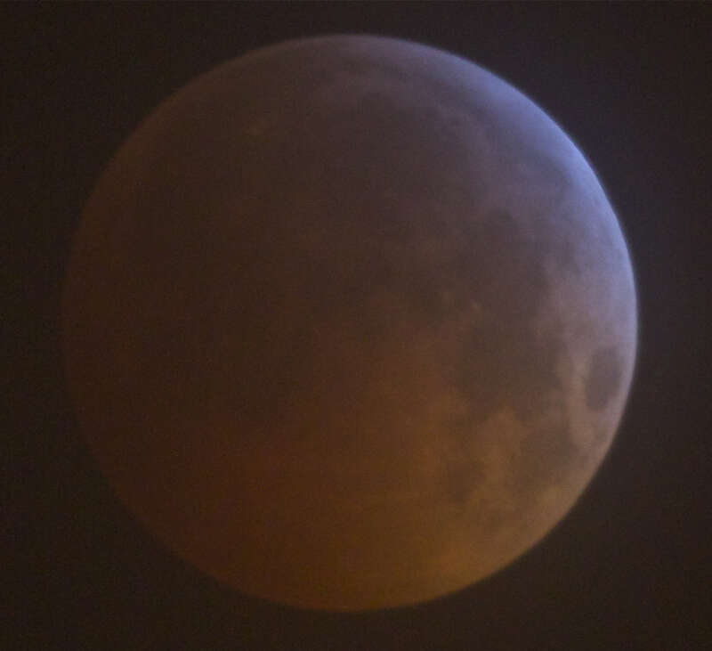 here's a nice long exposure, high quality shot, just as it was fully eclipsed.
2.5 seconds at iso400 through an f4.0 telescope on a mount.  the clouds were coming in so it's a bit hazy (or cloudy, I guess)

the upper right is only obscured by the