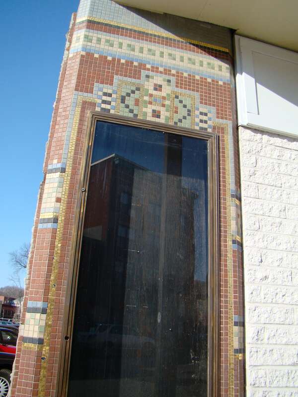 Poster window with tiling from Lord Cinema. The historic May Building (built 1908) was demolished, leaving the non-historic Sears Building (built 1945) retaining the advertising facade of the cinema.
