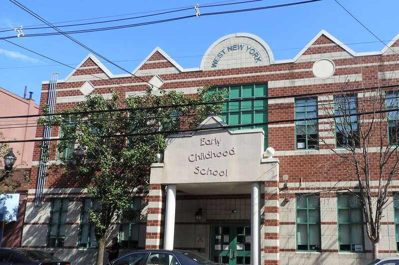 Looking east across Hudson Avenue at a school on a sunny late afternoon