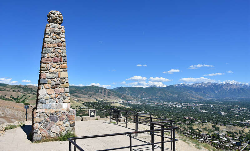 The 1934 monument atop Ensign Peak, with the Wasatch Mountains in the distance.