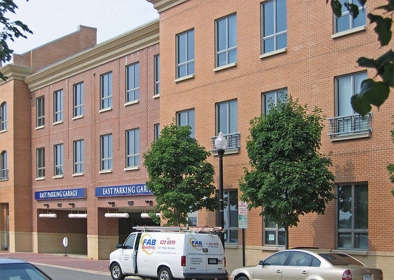 Entrance to parking strucutures for Patent and trademark offices.  townhomes on either side line the rear of the parking garage.
This work is licensed under a 
Creative Commons Attribution 3.0 United States License

Please Attribute to: Brett VA