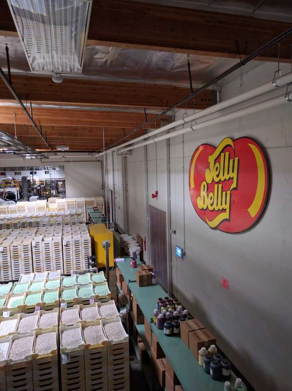 The interior of the Jelly Belly factory. The shelves at right contain ingredients used to make the trays of jelly beans to the left.