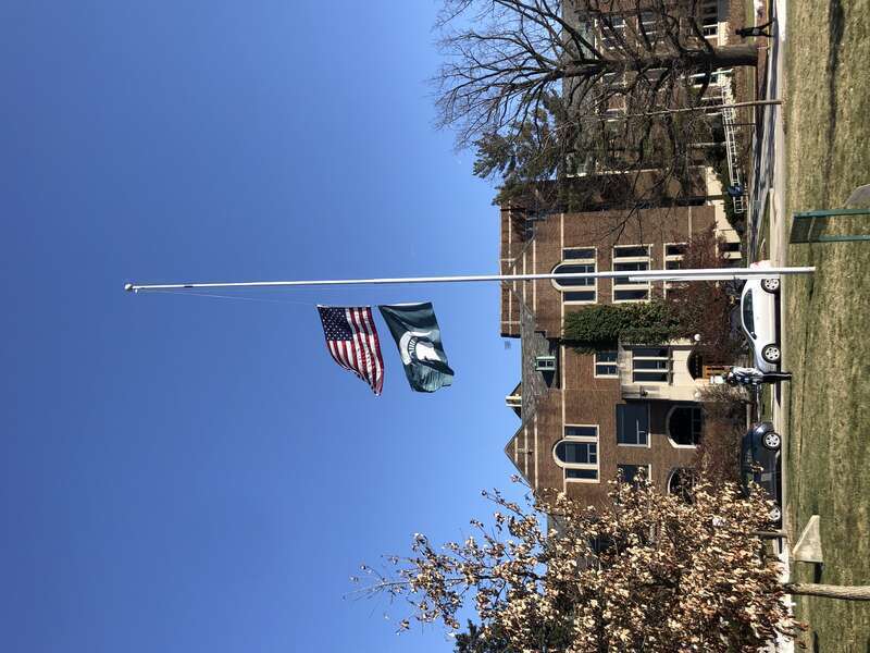 US and MSU flags at half mast in front of MSU Union after the 2023 Michigan State University shooting