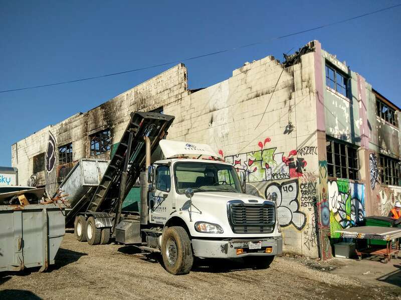 A truck hauling debris away from the Ghost Ship warehouse in Oakland,  California. The photo was taken 20 days after a fire that killed 36 people on December 2, 2016. Photo by Jim Heaphy.