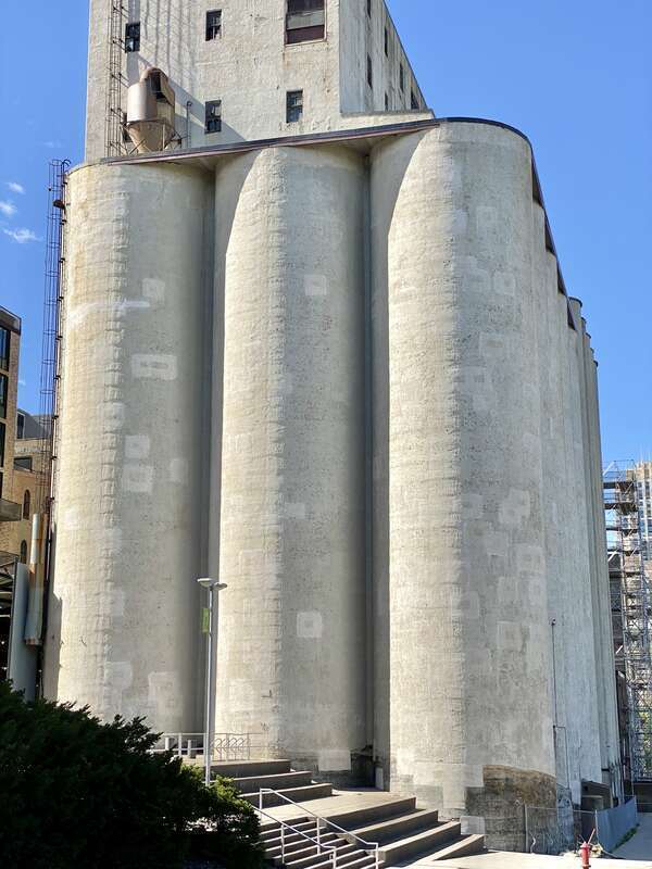 Built in 1908 by the Haglin-Stahr Company, this 185-foot-tall concrete structure was added to the adjacent Washburn, Crosby and Company A Flour Mill to increase production.  The structure consists of 15 cylindrical concrete bins with a 5-story