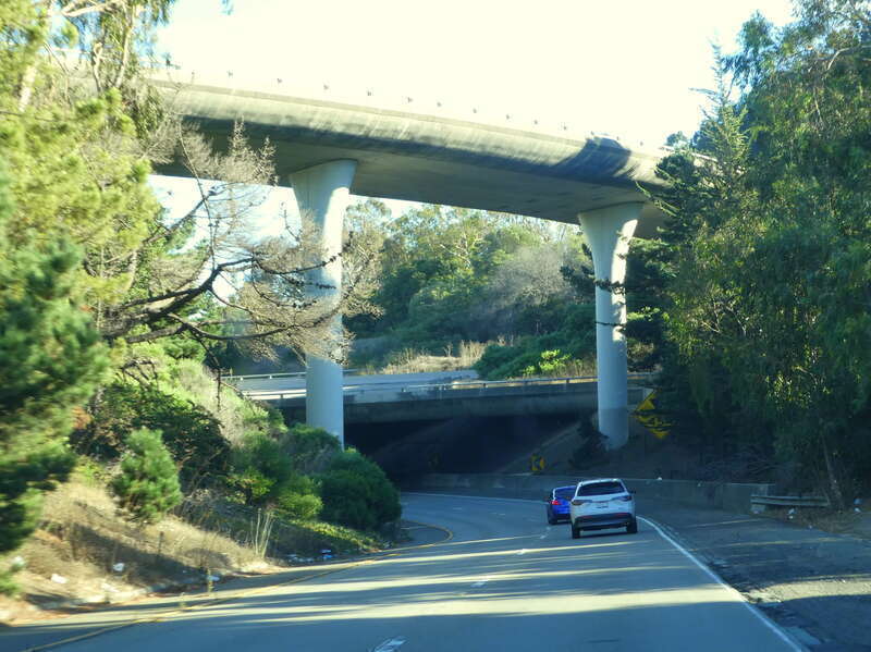 The I-280/I-380 interchange in San Bruno, viewed from the I-280S to I-380E ramp in October 2023. At top is the I-380W to I-280S ramp; below it is the ghost ramp for the never-built westward extension of I-380.