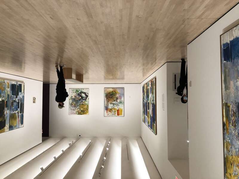 Museum guard and visitor at the Joan Mitchell retrospective, featuring more than 80 works by the artist. The exhibition ran from September 4, 2021–January 17, 2022 at the San Francisco Museum of Modern Art (SFMOMA).[1]  Photo by Steven Saylor.