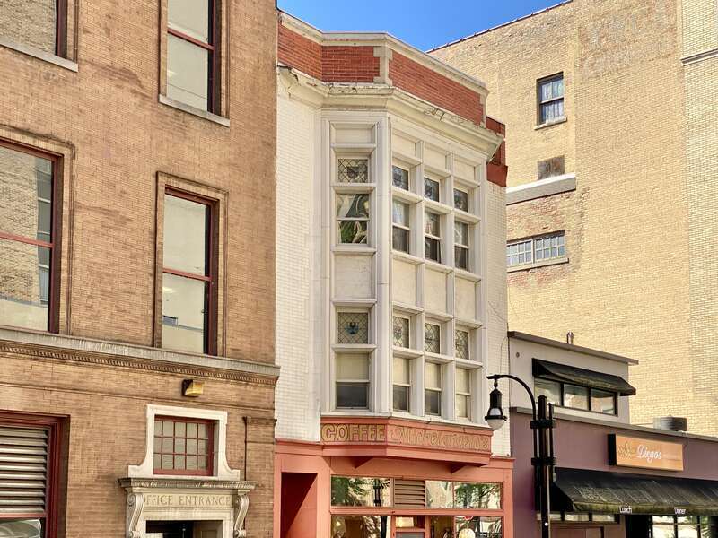 Built in 1905, this Tudor Revival-style building was designed by Claude and Starck for retired attorney F. J. Lamb.  The building is clad in red brick with a large Tudor Revival-style two-story oriel window with one-over-one windows and diamond pane