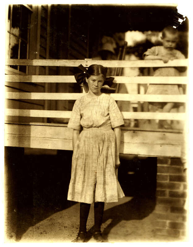 Lilly O'Sullivan, a frail 13 year old girl working in the Drayton Mills, Spartenberg [sic], S.C. Been working four years, weaving, spinning, etc. Ran from 4 to 6 looms. Gets $3 a week. Location: Spartanburg, South Carolina. Photograph by Lewis Wickes