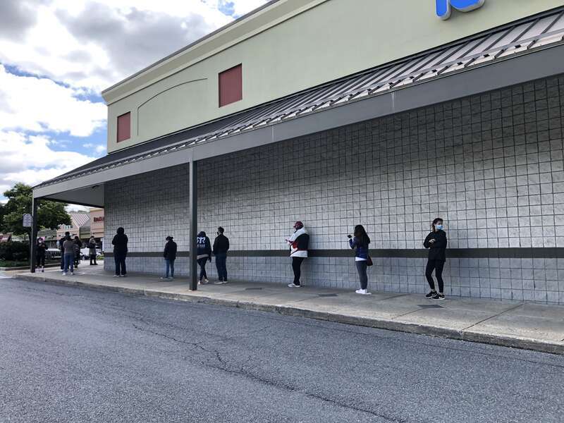 Line of customers waiting to enter the Trader Joe's location in North Bethesda, MD