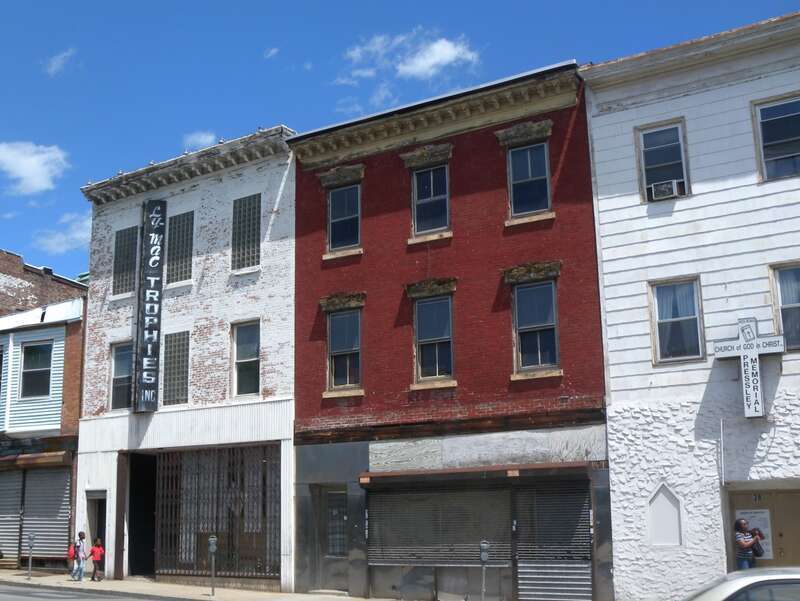 Looking east across Wharburton Avenue at Ly Mac Trophies and other shops on a sunny early afternoon.