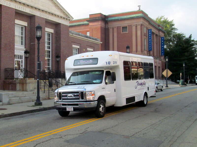 An inbound Joseph's Limousine bus on the MBTA route on Forest Street at Medford Square in July 2015