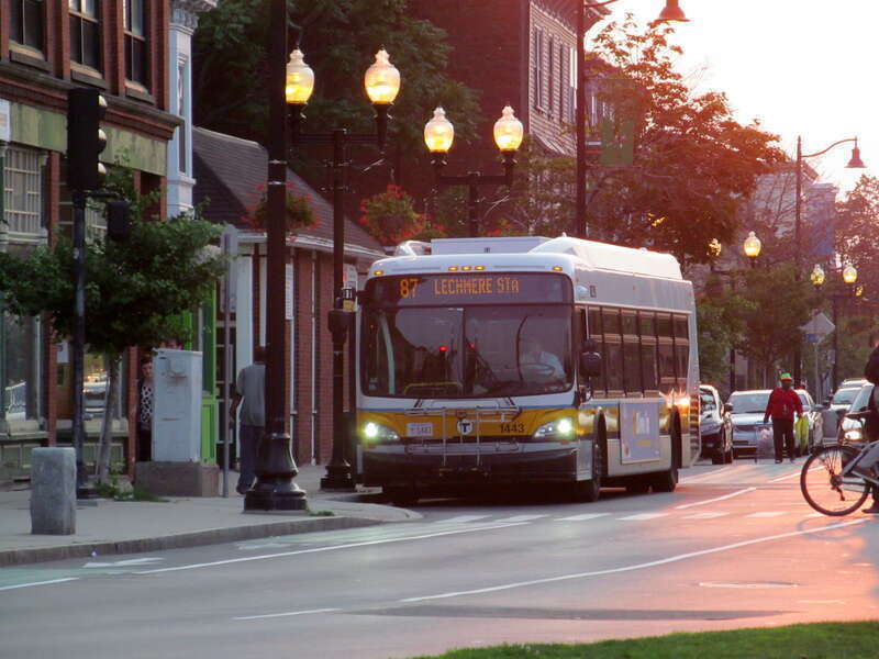 An inbound #87 bus approaches Union Square on Somerville Avenue