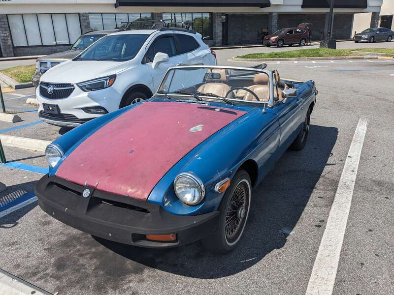 An MG MGB with mismatched panels parked in Palm Bay, Florida