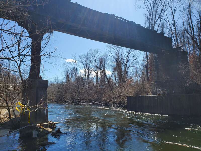The partially-destroyed Meriden, Waterbury and Connecticut River Railroad bridge over the Naugatuck River, seen in March 2023