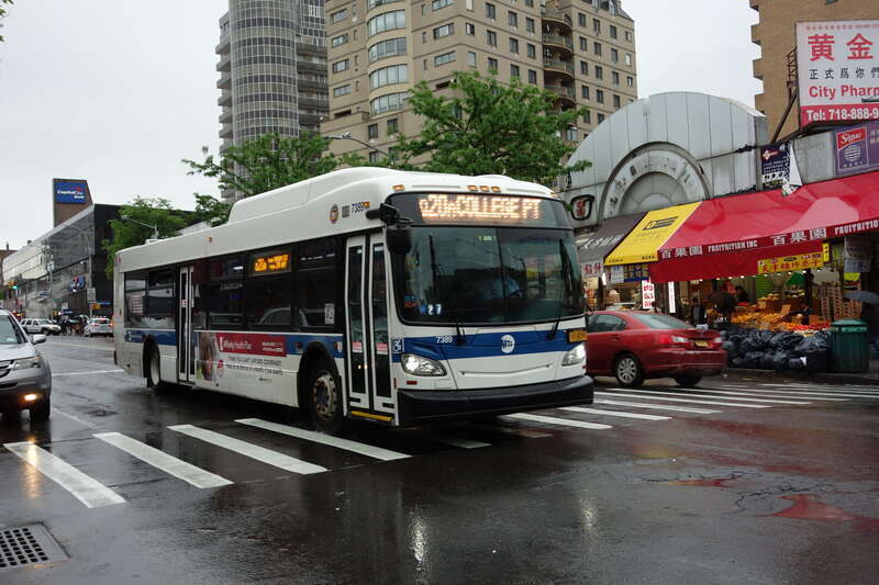 A College Point–20th Avenue-bound Q20A local bus traveling north on Main Street at 41st Road in Downtown Flushing, Queens.