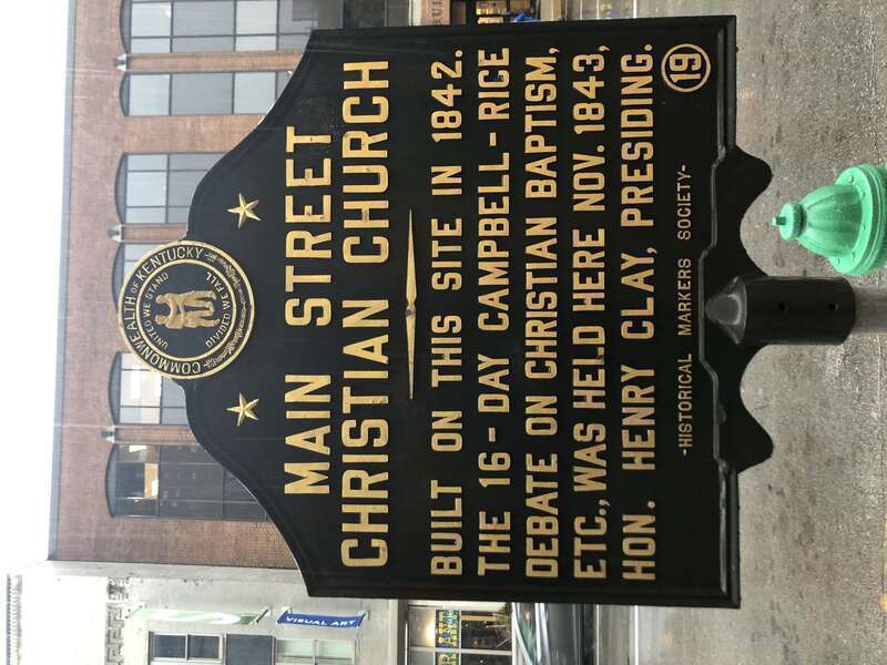 Historical Marker number 19 commemorates the site of the Main Street Christian Church. Built in 1842 it was the site of the Campbell-Rice Debates on Christian Baptism presided over by Henry Clay. The building was razed in 1903.
