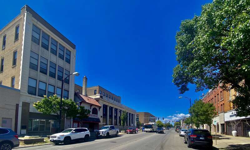 On a sunny June 2022 afternoon in Buffalo, New York, a South Buffalo-bound NFTA Metro bus on route #23 plies its prescribed route along Fillmore Avenue at the core of the city's historically Polish-American neighborhood. The bus is headed for the