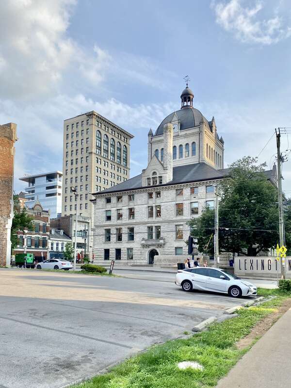 On the left, built in 1898-1900, this Richardsonian Romanesque Revival-style building was designed by Lehman and Schmitt to serve as the Fayette County Courthouse, and is the fifth courthouse to serve Fayette County, replacing a previous courthouse,