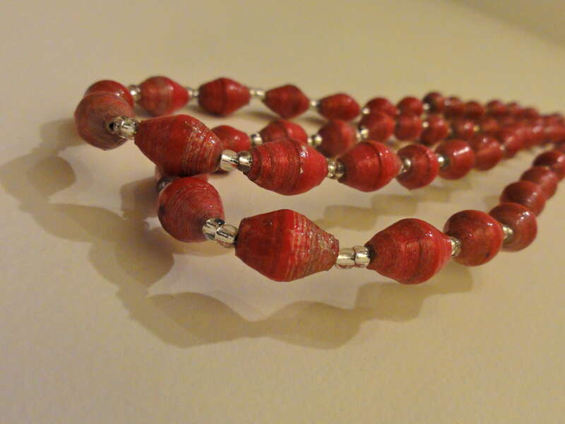 Paper to Pearls necklaces are individually made pieces. The paper beads are covered with an acrylic finish that makes them waterproof and durable.