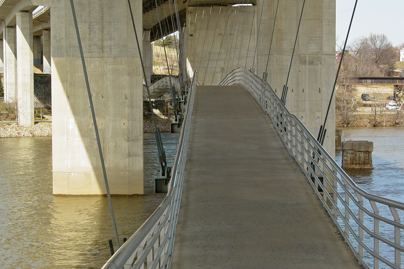 The Belle Isle pedestrian bridge, suspended by cables from the Robert E. Lee Memorial Bridge in Richmond, Virginia.

Ben Schumin is a professional photographer who captures the intricacies of daily life.  This image may be used under Creative Commons