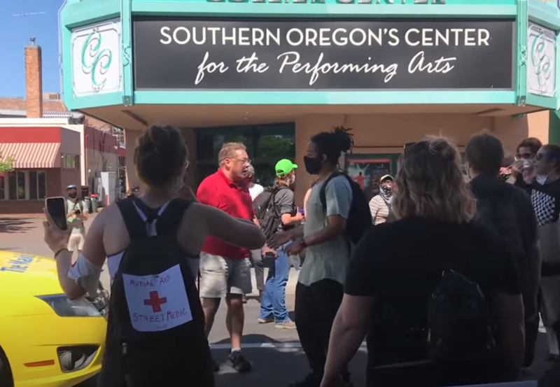 Phoenix, Oregon Mayor Chris Luz (in red) arguing with Medford, Oregon marchers on June 1 2020. Full-length video from Keegan Van Hook is on Youtube; this specific screenshot is licensed CC-BY-SA, the video and other screenshots are not covered in