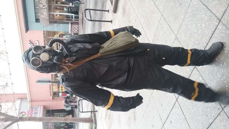 A protestor wearing a gas mask and protective gear at the inauguration day of Donald Trump in Santa Cruz, California, USA