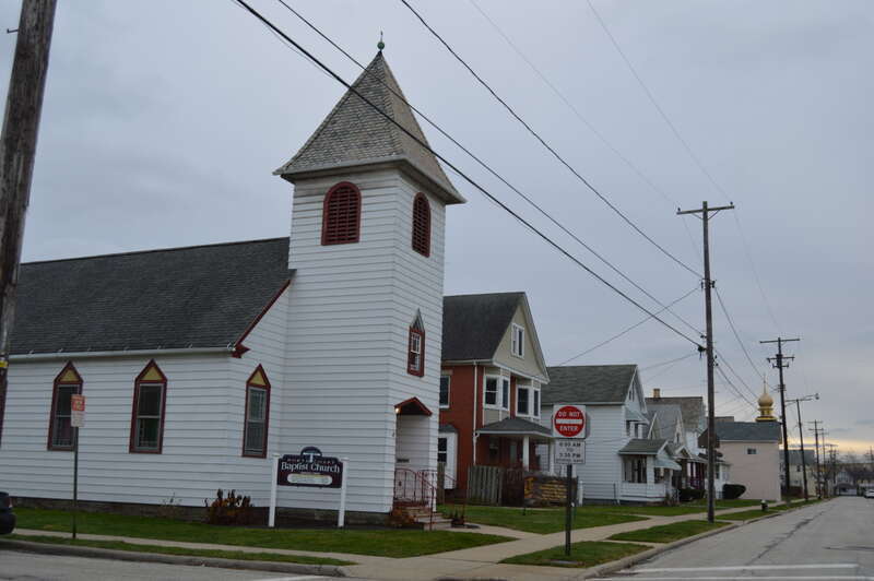 Looking south on Quail Street at the Thrush Street intersection in Lakewood, Ohio, United States.  Close to the camera is the North Coast Baptist Church, while St. Nicholas' Ukrainian Orthodox Church is visible in the distance.  This neighborhood is
