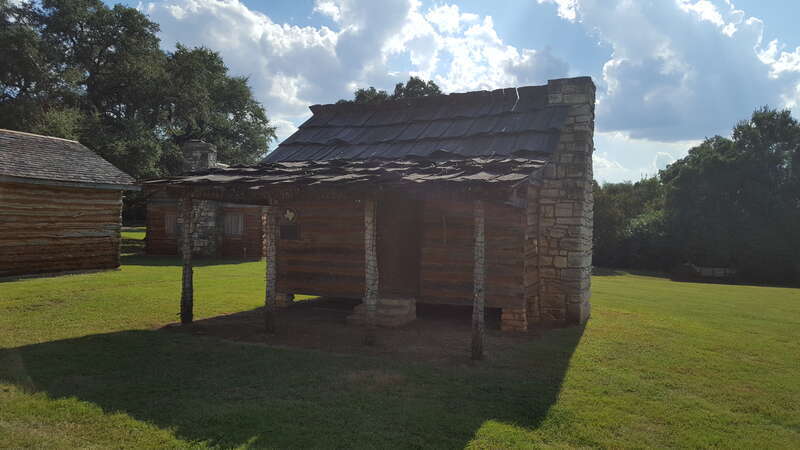 Cabin of squared logs and hand-hewn limestone was built in the early 1850s near the village of Gabriel Mills, Texas.  It stood on property owned in 1850-53 by Samuel Mather (1812-78), miller and blacksmith who first settled the area.  The structure