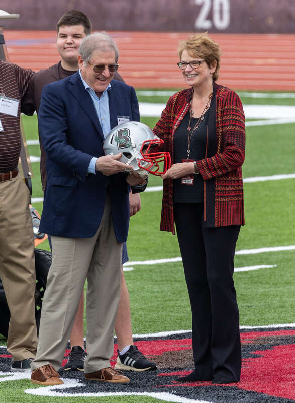 Brown President Christina Paxson honors Richard Gouse '68, the primary donor of the new Richard Gouse Field at Brown Stadium. Ceremony during halftime of the first game on the new field, 18 September 2021.