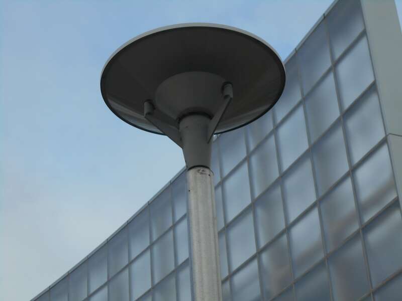 These are okay, but I like the old style cast iron lamp posts better.  They do have the cap to keep from leaking light pollution into the sky.  Maybe the old style lamp fixtures could have been retrofitted to prevent light going straight up via