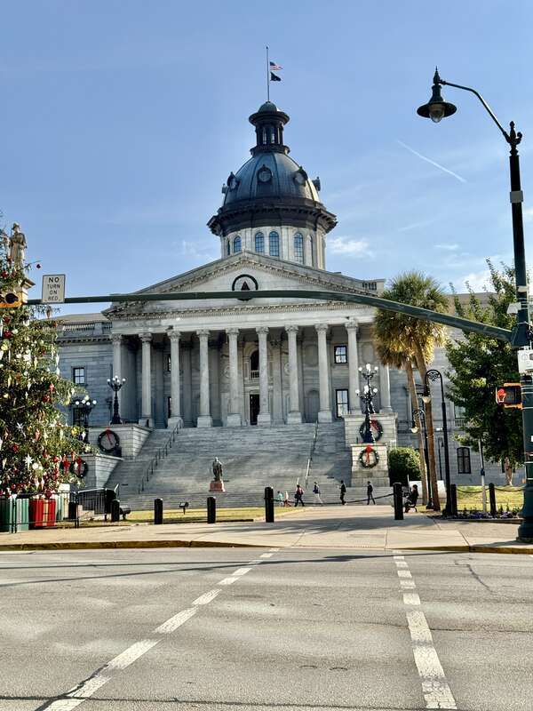 Built in 1851-1907, this Classical Revival-style building was designed by P. H. Hammarskold, John Niernsee, Frank McHenry Niernsee, Frank Pierce Milburn, and Charles Coker Wilson to serve as the state capitol building for South Carolina.  The