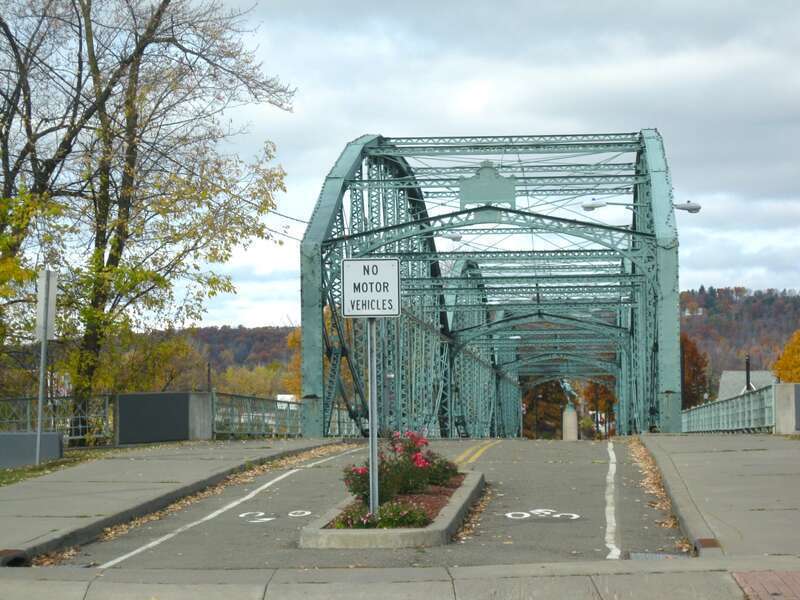 The South Washington Street Parabolic Bridge, in Binghamton, New York, is listed on the U.S. National Register of Historic Places. The bridge was built in 1886 and was closed to motorized traffic in 1969. This is the south end of bridge.