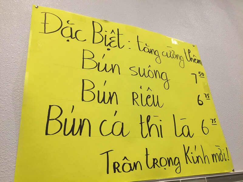 A handwritten sign advertises the current specials at Cơm Tấm Thuận Kiều, a Vietnamese restaurant on Brookhurst Street in Garden Grove, California. Though the restaurant specializes in cơm tấm dishes, the specials are all rice vermicelli dishes.
