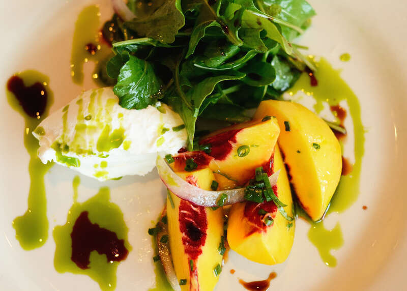 Stone Hollow Goat Cheese Salad with peaches marinated in basil, J3 organics arugula, basil oil, vin cotto

Delicious salad at Ollie Irene in Mountain Brook, Alabama