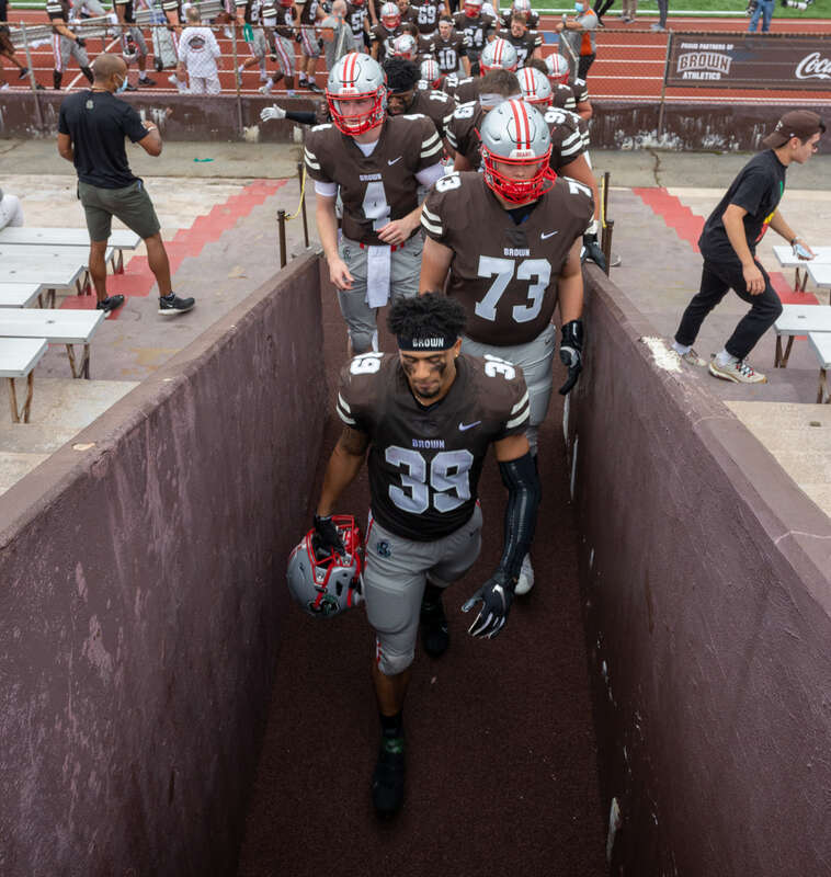 The Brown Bears football team files off the field at halftime, led by no. 39, Allen Smith. Brown Football vs. URI, 18 September 2021.