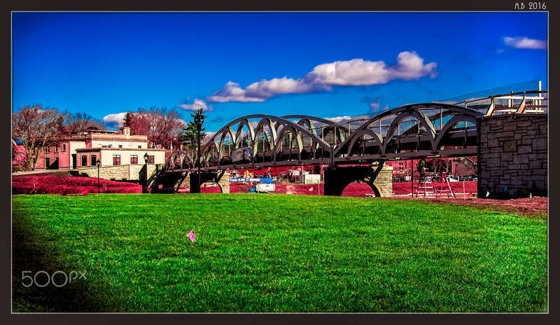500px provided description: The Walking Bridge At The Hub Park In Meriden [#park ,#sky ,#morning ,#buildings ,#grass ,#green ,#filter ,#microsoft ,#Topaz Effects ,#Meriden CT ,#Landscape ,#Adobe ,#Pentax ,#Blue Sky ,#Connecticut ,#CT ,#Photoshop CS6