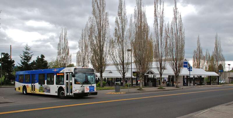 TriMet's Tigard Transit Center, in Tigard, Oregon, with a bus (No. 2935, a 2009 New Flyer D40LFR) exiting onto Commercial Street, headed for Beaverton TC on route 78.  The transit center opened for buses in 1988.  A commuter-rail station was opened