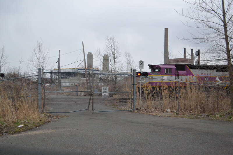 A Newburyport/Rockport Line train crosses a private grade crossing in April 2012. Several years later, the Encore Boston Harbor casino was built just behind the crossing.