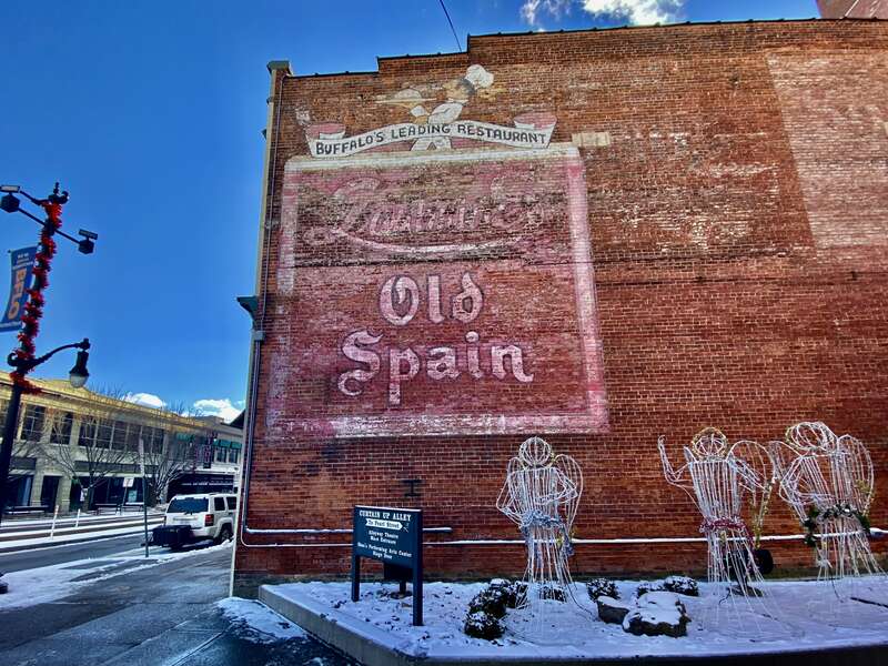 As seen in January 2022, a well-preserved ghost sign on the north side of the building at 660 Main Street in downtown Buffalo, New York (now home to Shea's Smith Theater) identifies it as the onetime site of "Buffalo's Leading Restaurant", Laube's