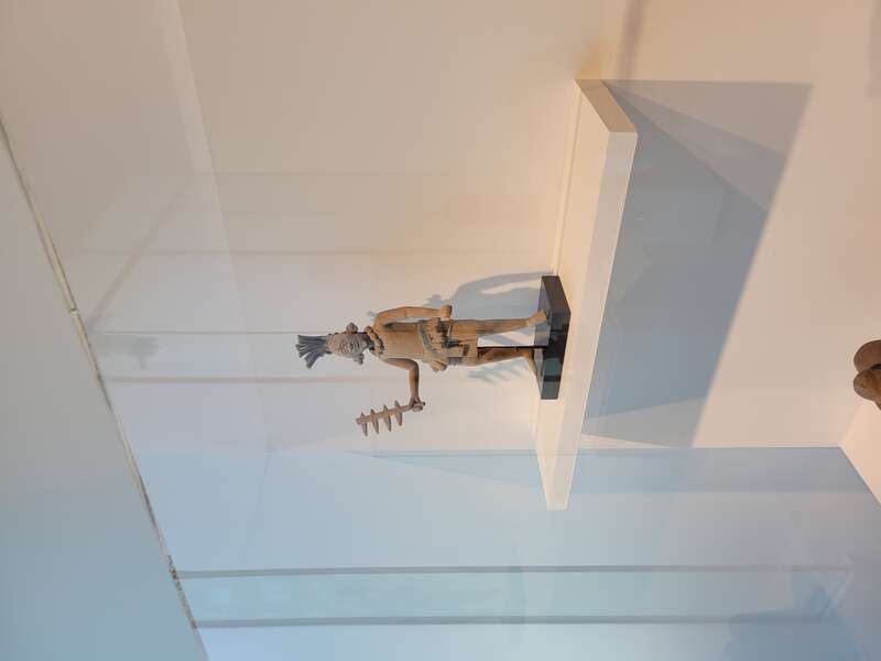 A Maya ceramic figure photographed at the Tucson Museum of Art in 2021, loaned from Paul L. and Alice C. Baker.
The figure is in a style associated with Jaina Island, Campeche, Mexico, and likely depicts a soldier, wielding a removable bladed club or